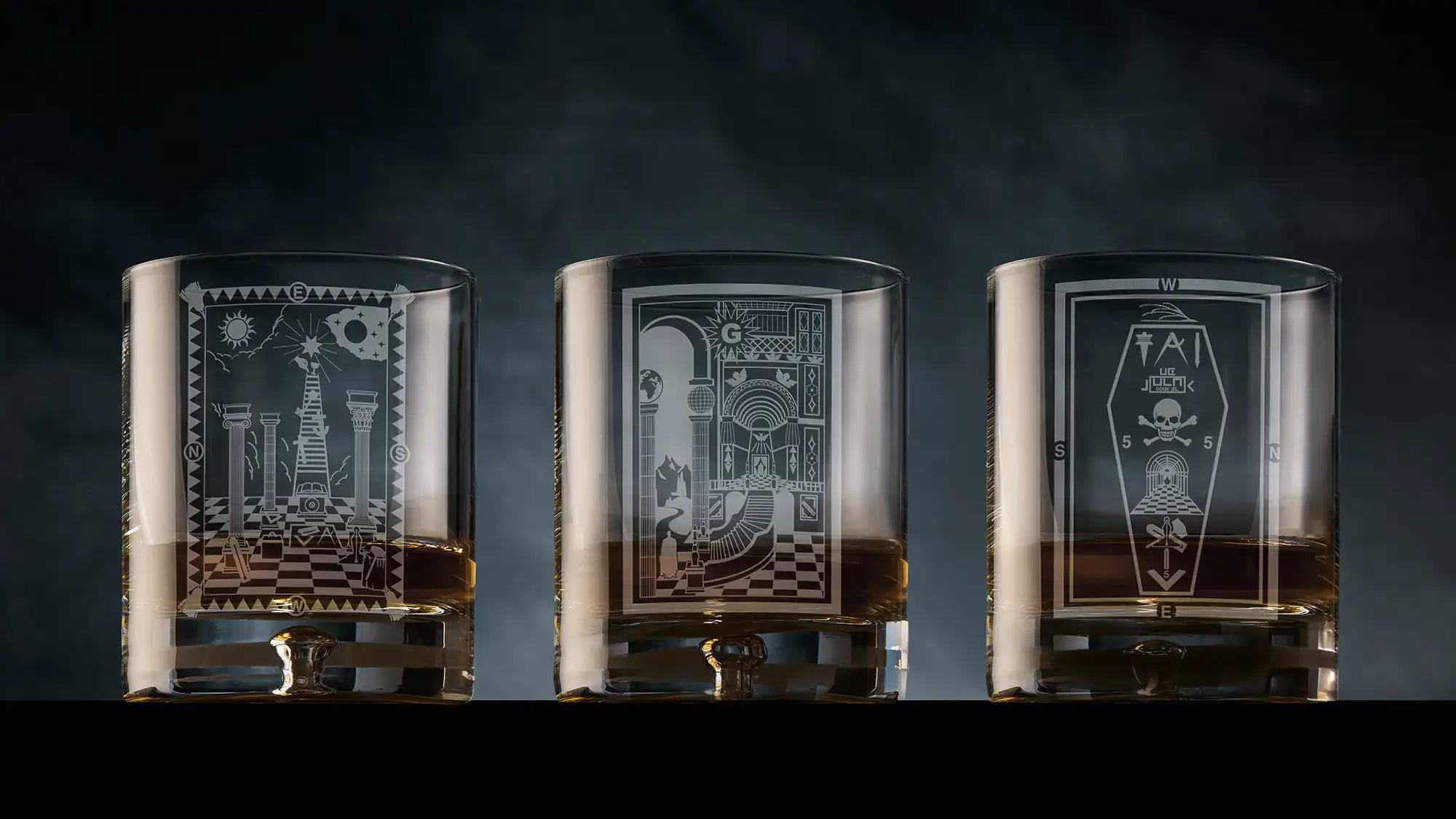 Engraved whisky glass set displaying Master Mason, Fellowcraft and Entered Apprentice tracing board designs.