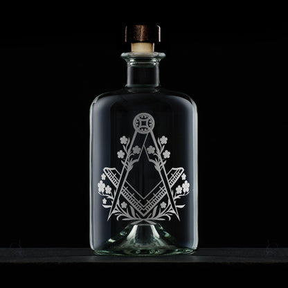 Engraved Masonic decanter with Square & Compass and Forget-Me-Not motif, photographed on black background