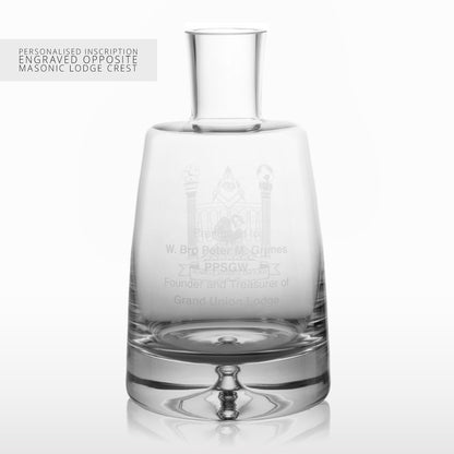 Clear glass whisky decanter with engraved text on a white background