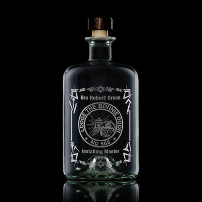 Custom Masonic apothecary decanter with engraved lodge crest, shown on black background