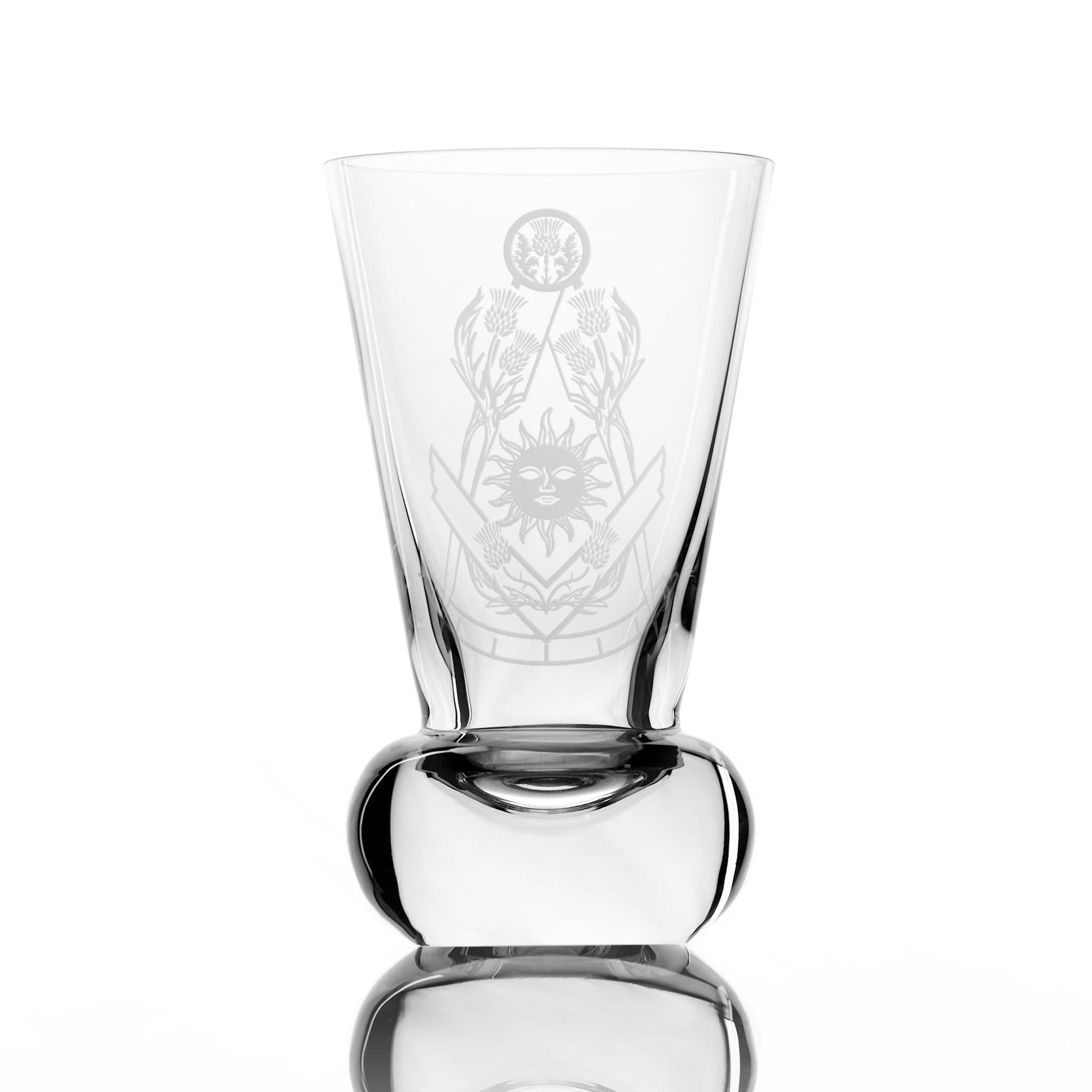 Masonic firing glass engraved with thistles and square and compass design of the right worshipful master on a white background