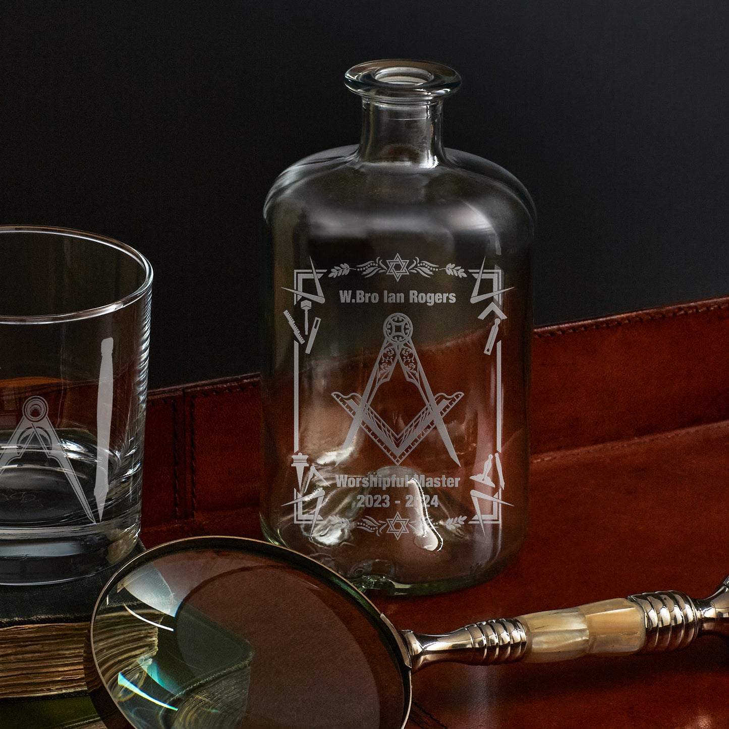 engraved apothecary bottle etched with working tools, freemasonry symbols and square and compass