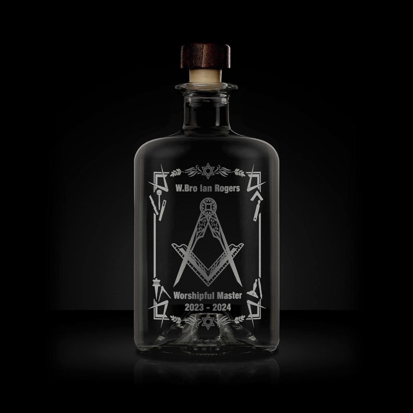 engraved apothecary bottle etched with working tools, freemasonry symbols and square and compass