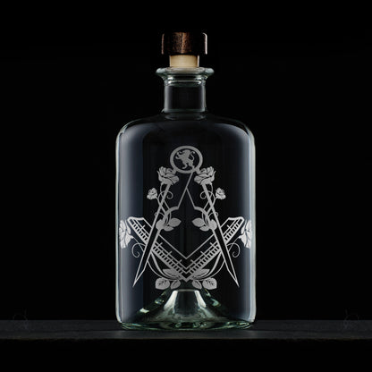 Engraved Masonic apothecary decanter with Square & Compass, English roses, and Lion Rampant, shown on black background