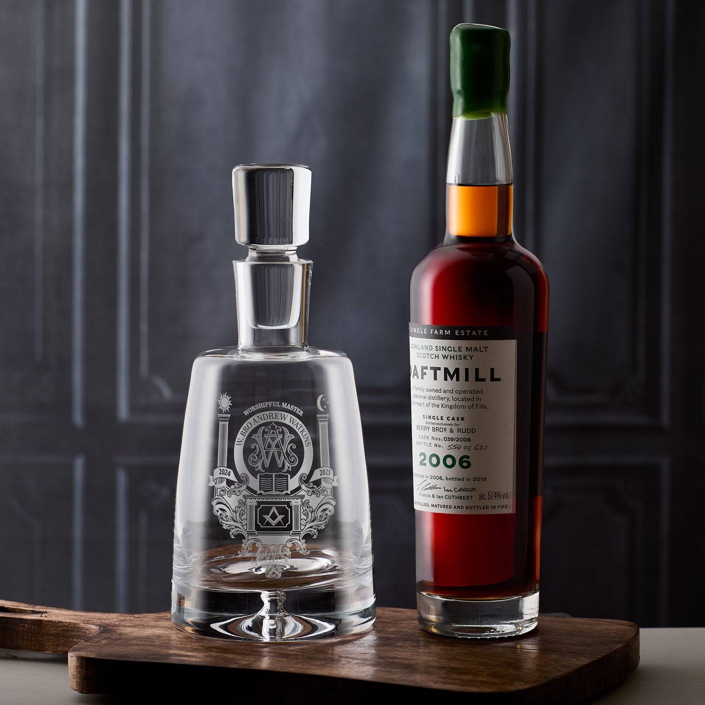 Personalised whiskey decanter featuring worshipful master and masonic symbols on a wooden surface with a dark textured background