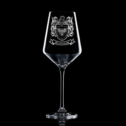 heraldic shield engraved on elegant wine glass — permanent, heirloom finish.