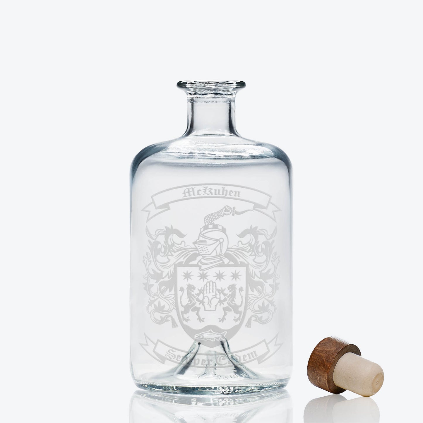 Heraldic crest on apothecary-style spirit bottle — deep, permanent engraving; ideal for milestone gifts.