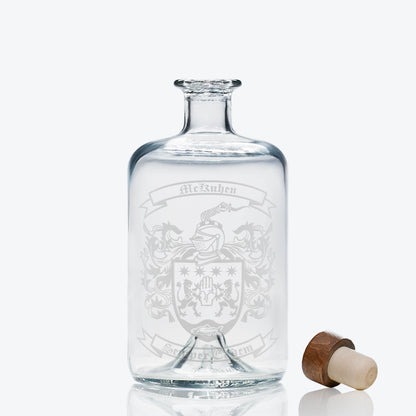 Heraldic crest on apothecary-style spirit bottle — deep, permanent engraving; ideal for milestone gifts.