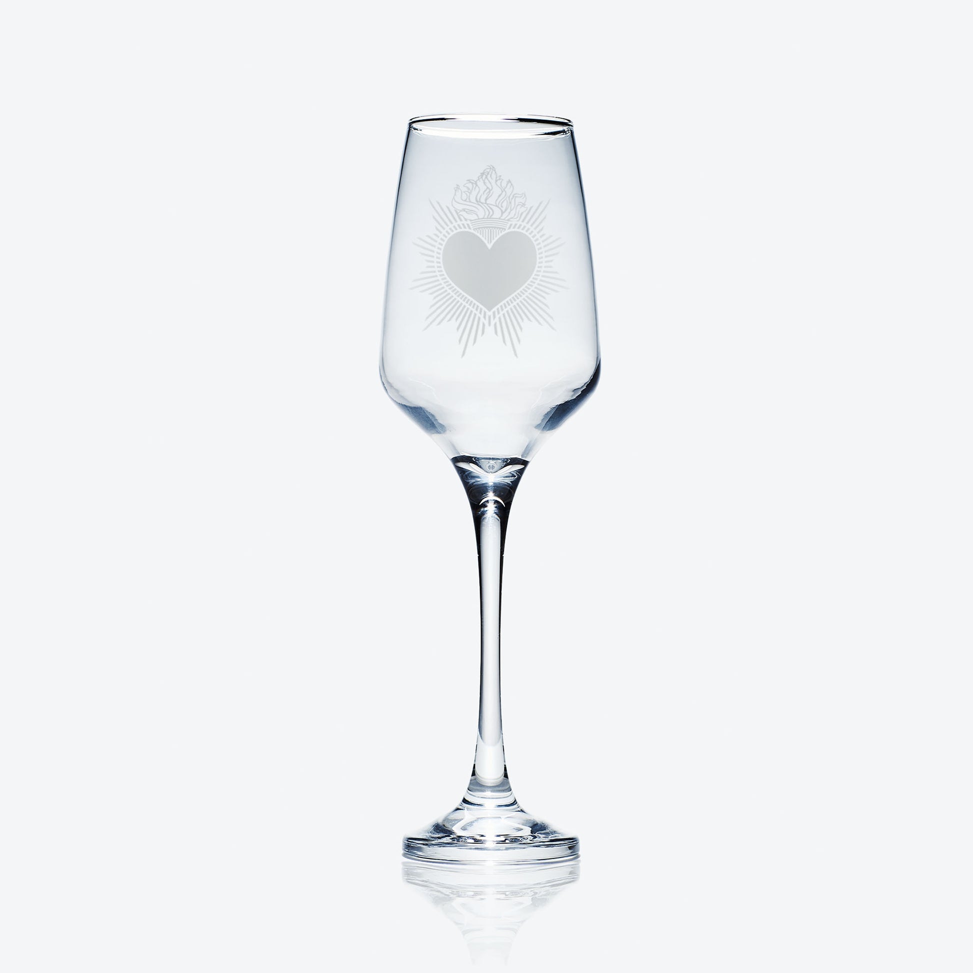 engraved milagro sacred heart prosecco glass or champagne flute on a white background