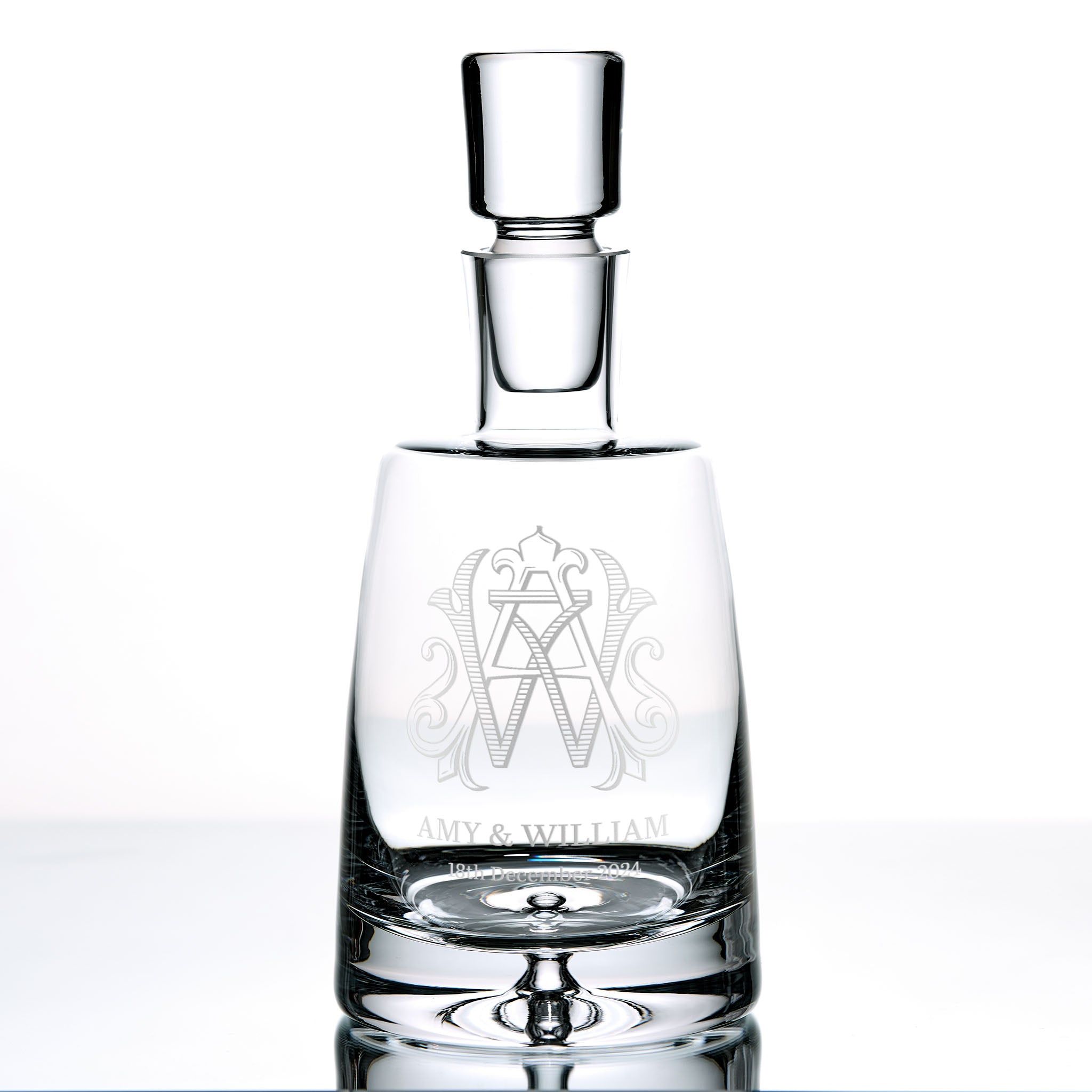 Monogrammed luxury decanter engraved with intertwined initials, displayed on a white background