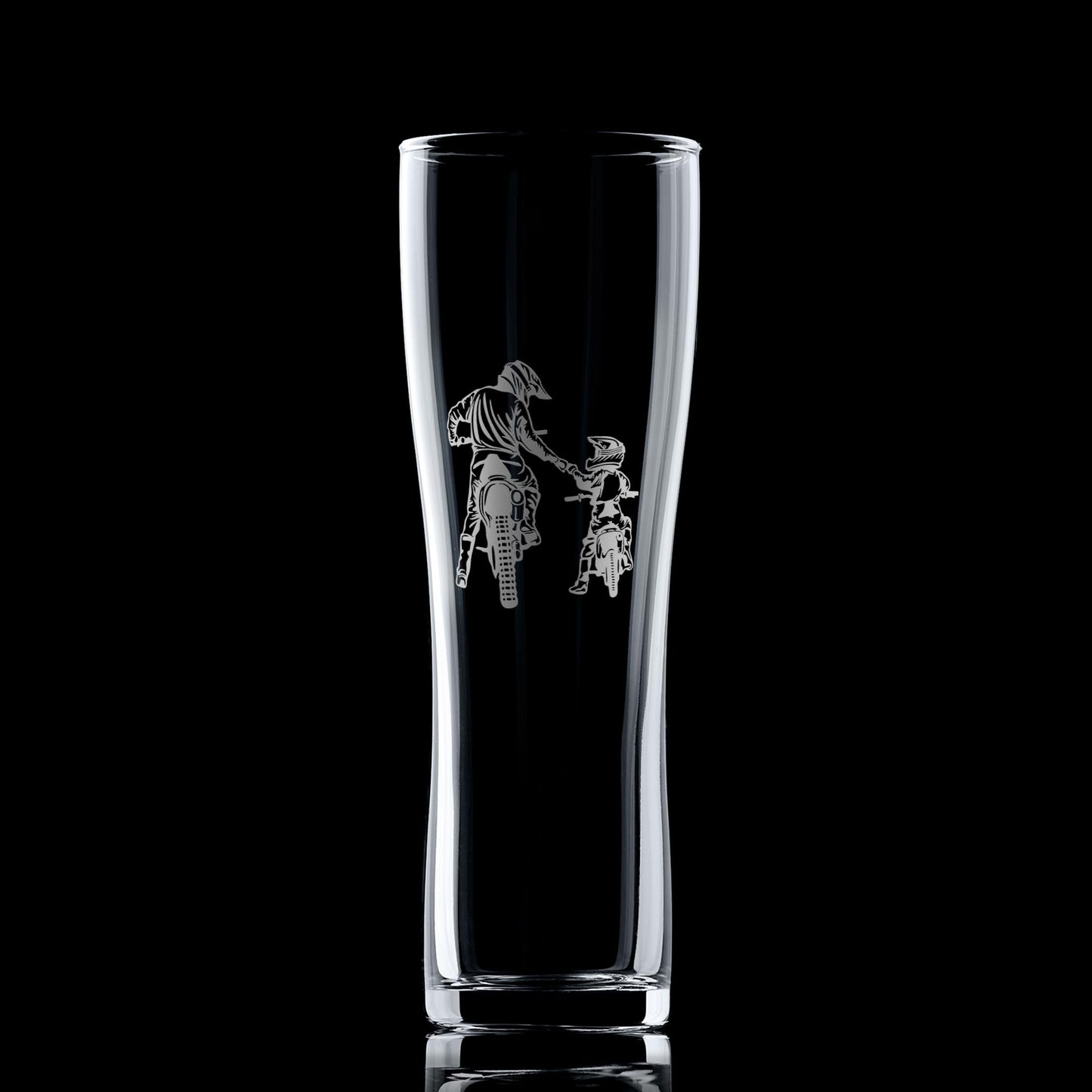 Clear glass tumbler with engraved design of a person on a motorcycle a black background