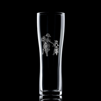 Clear glass tumbler with engraved design of a person on a motorcycle a black background