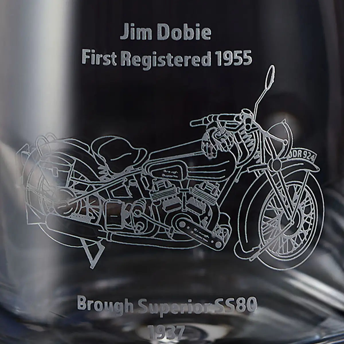 Engraved illustration of a motorcycle on a glass surface with text about the Brough Superior SS80.