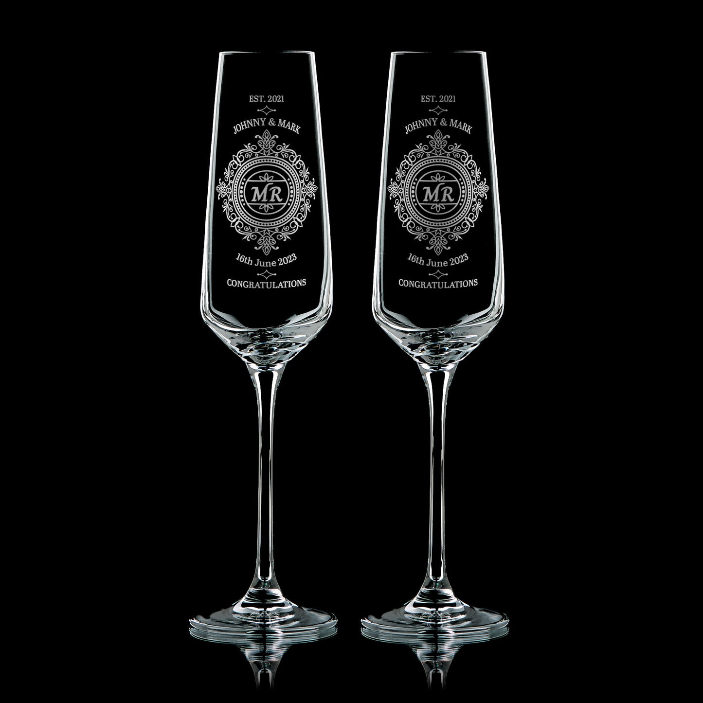 Pair of engraved Mr & Mr champagne flutes with lace-inspired design, names, and wedding date