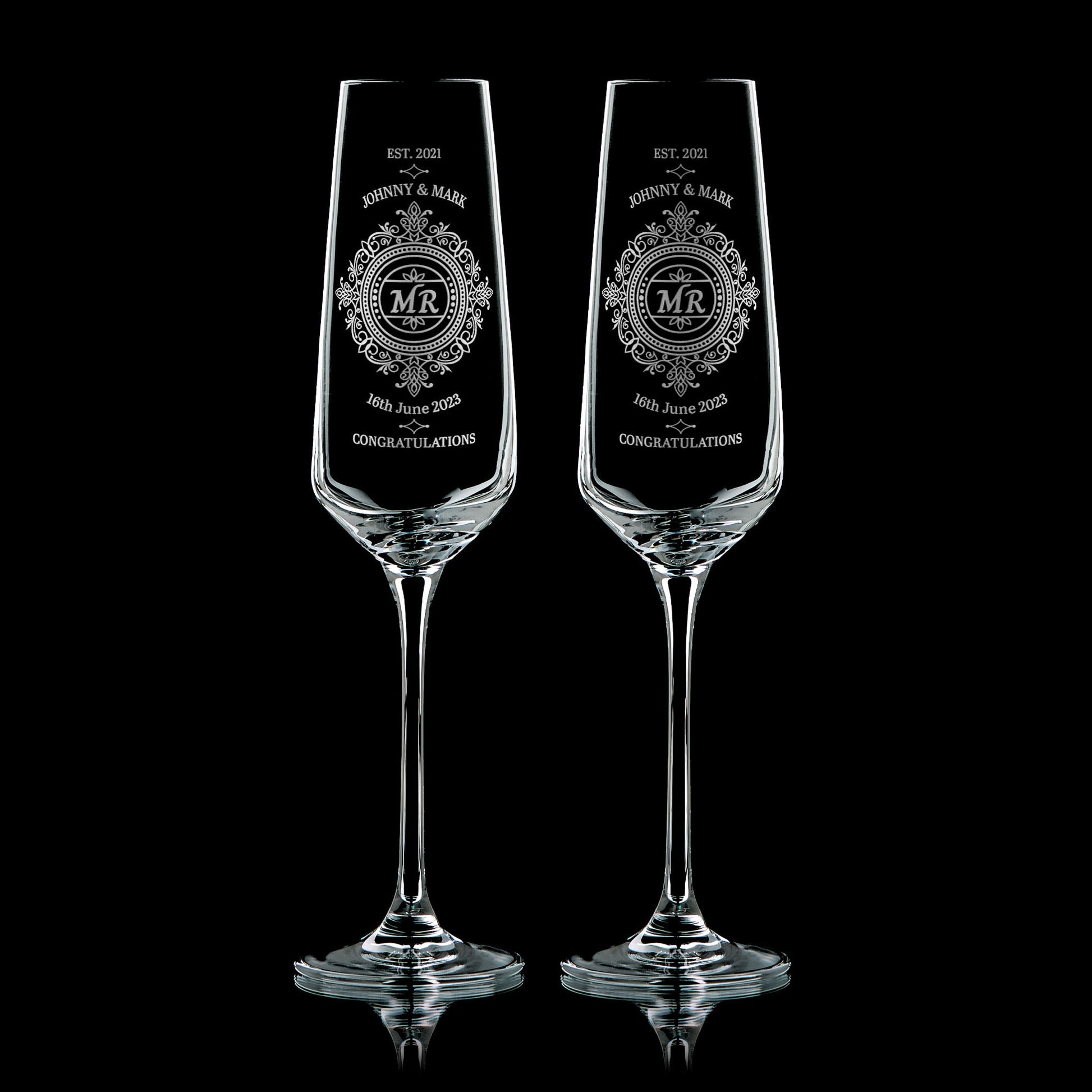 Pair of engraved Mr & Mr champagne flutes with lace-inspired design, names, and wedding date
