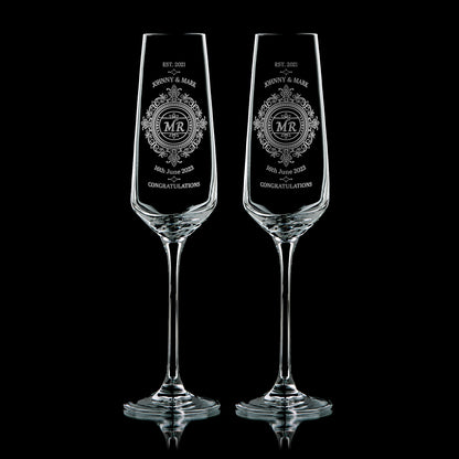 Pair of engraved Mr & Mr champagne flutes with lace-inspired design, names, and wedding date