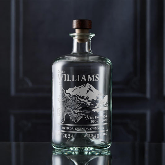 Decanter with wooden cap engraved with Mount Snowdon in Wales on a dark background