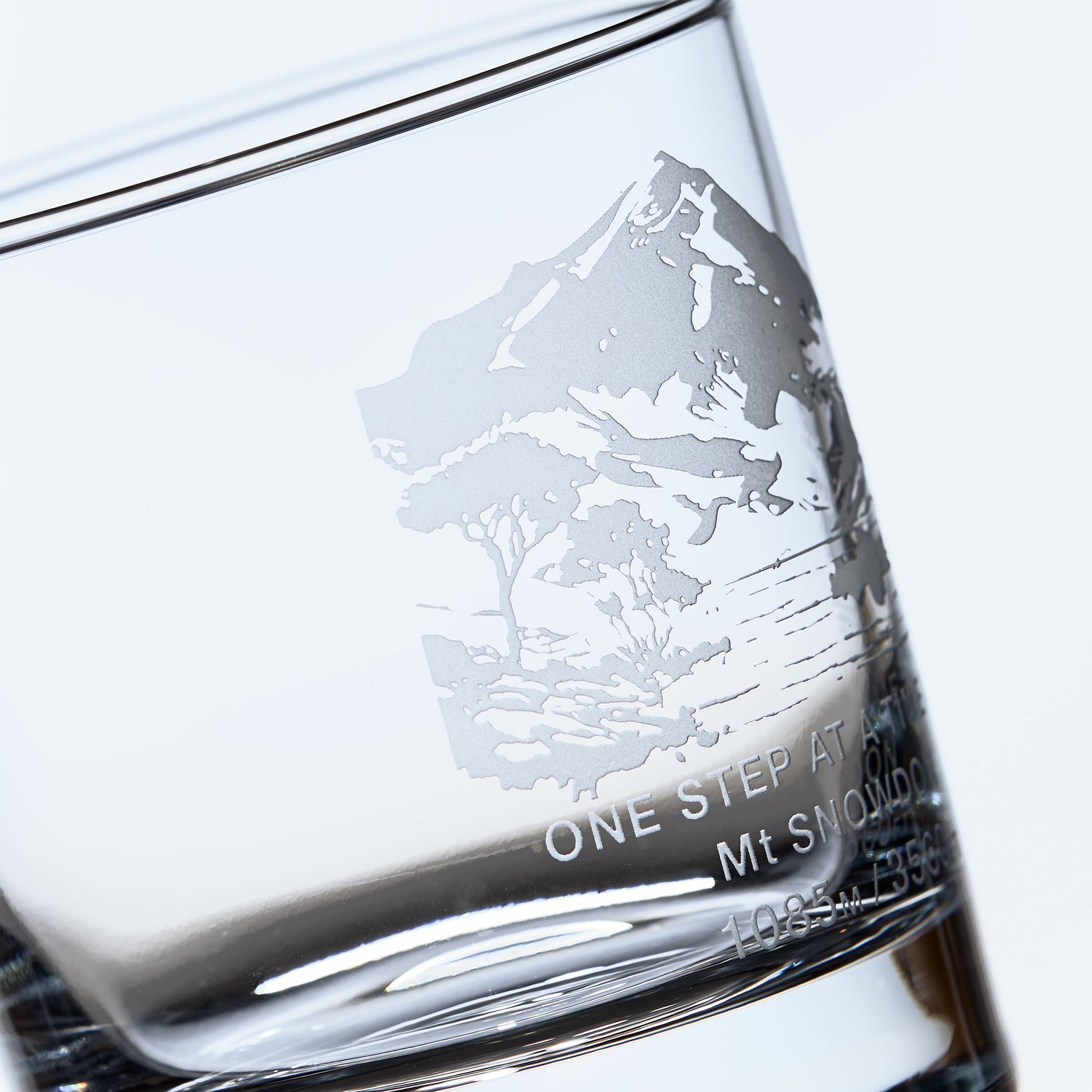 close up detail of a whisky glass engraved with Mt Snowdon in Wales