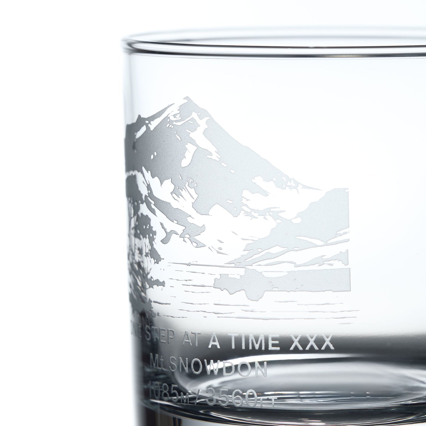 Close-up detail of a personalised whisky glass engraved with Mt Snowdon in Wales and engraved message