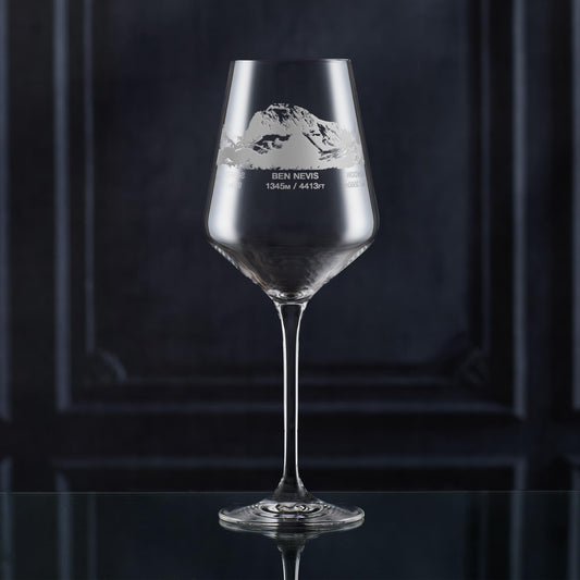 Hillwalkers wine glass with engraved 3 peaks mountain design and text on a dark background