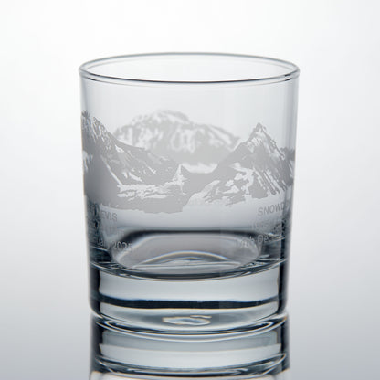Whisky glass engraved with Ben Nevis and Snowdon from the National Three Peaks design, photographed on a white background