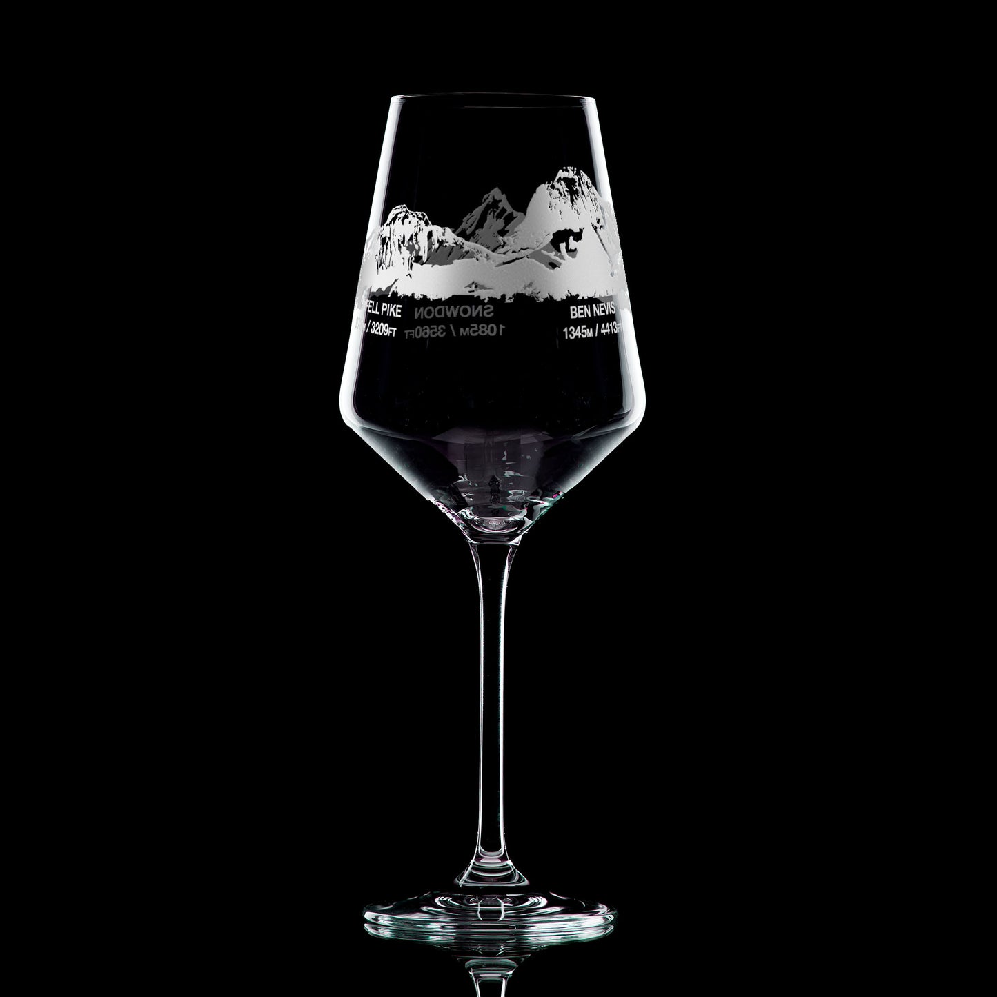 Wine glass engraved with Scafell Pike, Snowdon and Ben Nevis, photographed on a black background