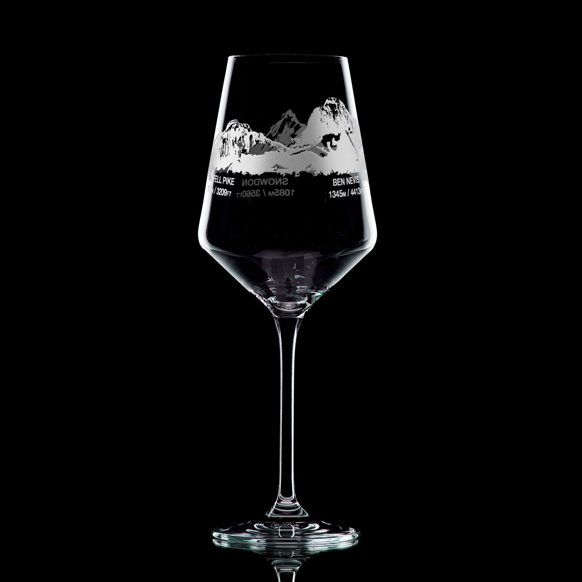 Wine glass engraved with Scafell Pike, Snowdon and Ben Nevis, photographed on a black background