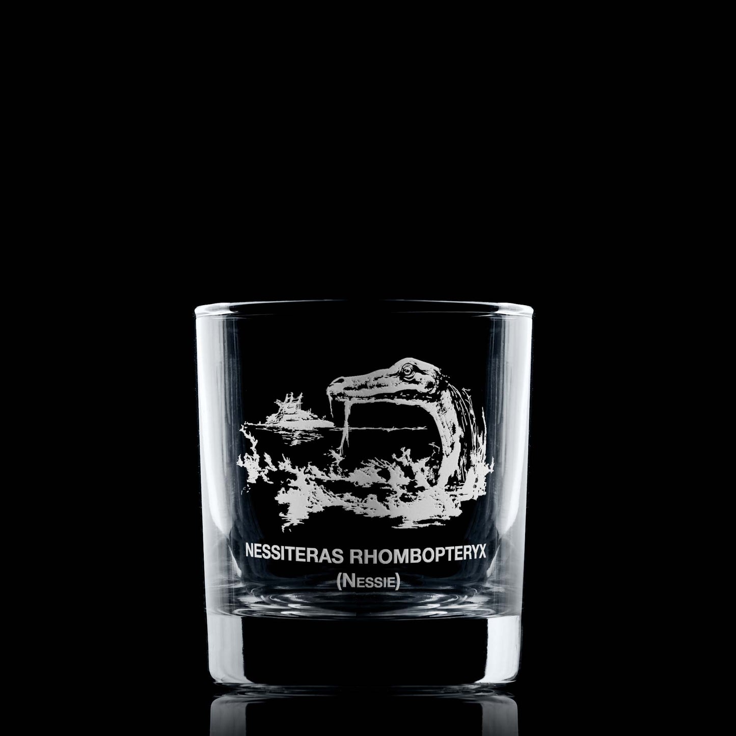 Loch Ness whisky glass with Nessie, a boat in the distance, and Latin text