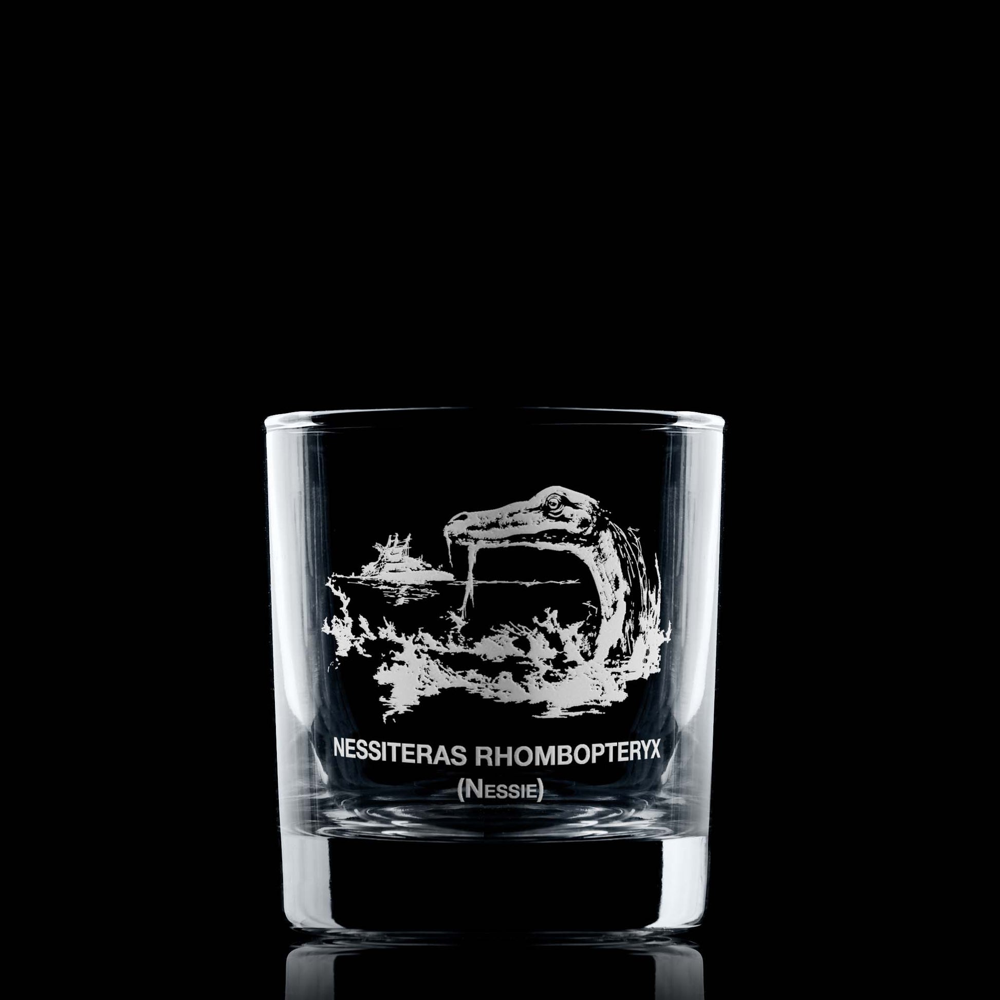 Loch Ness whisky glass with Nessie, a boat in the distance, and Latin text