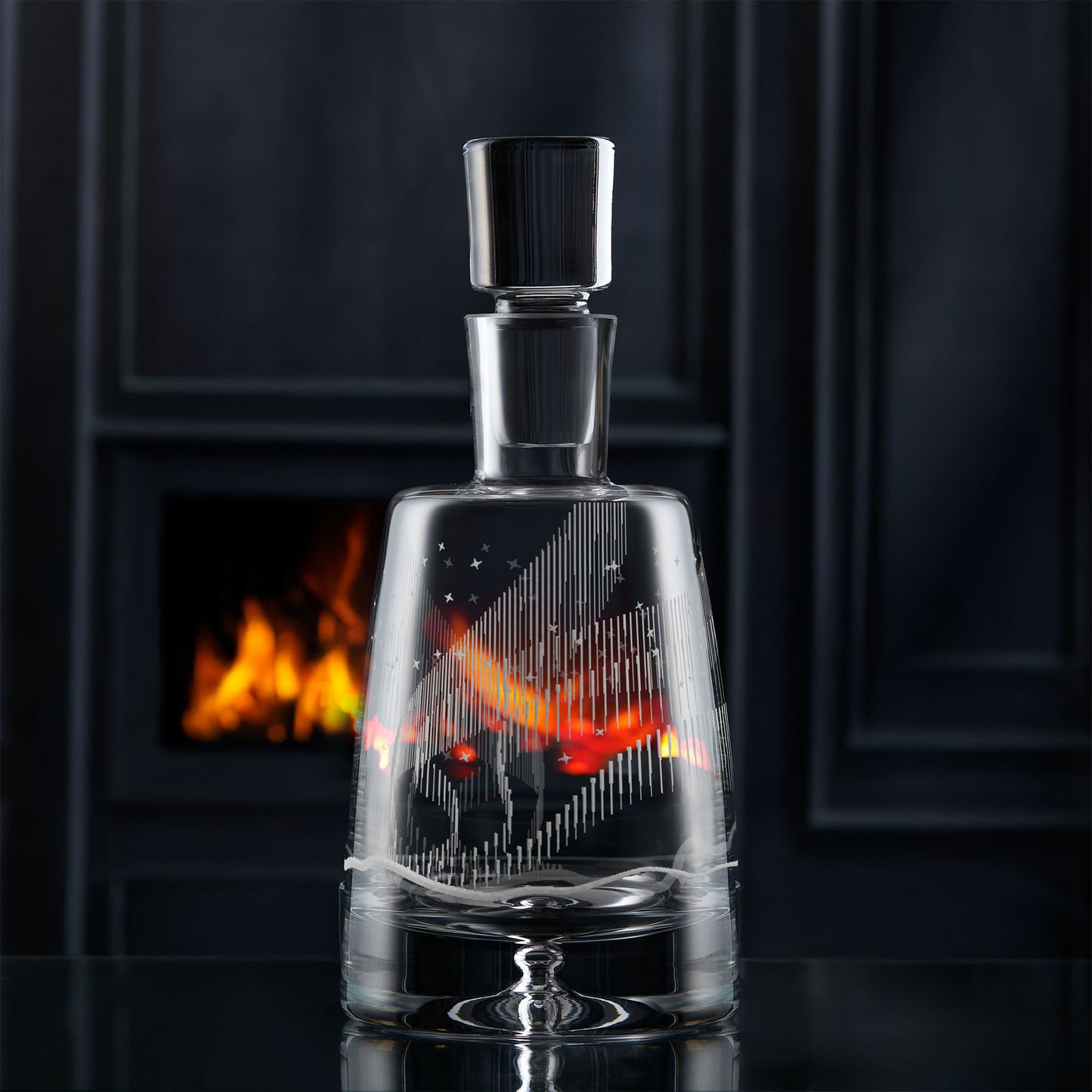 Luxury spirit decanter with an engraving of the northern lights and stars on a dark background
