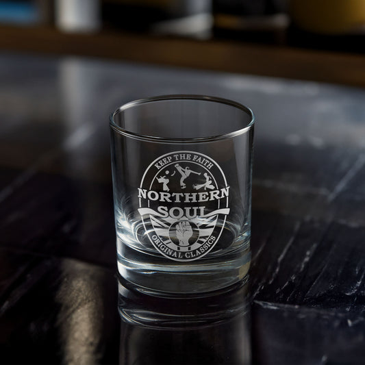 Clear whisky glass with engraved Northern Soul design on a dark surface