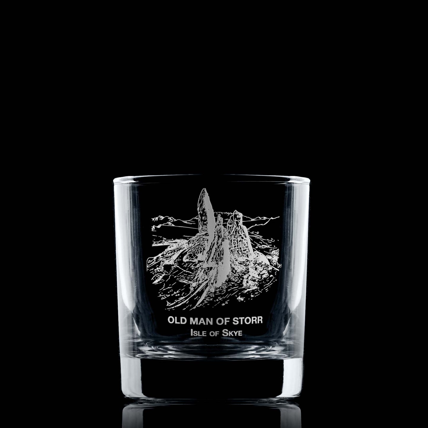 Engraved whisky glass featuring the Old Man of Storr and Isle of Skye text, shown on black background to highlight engraving detail