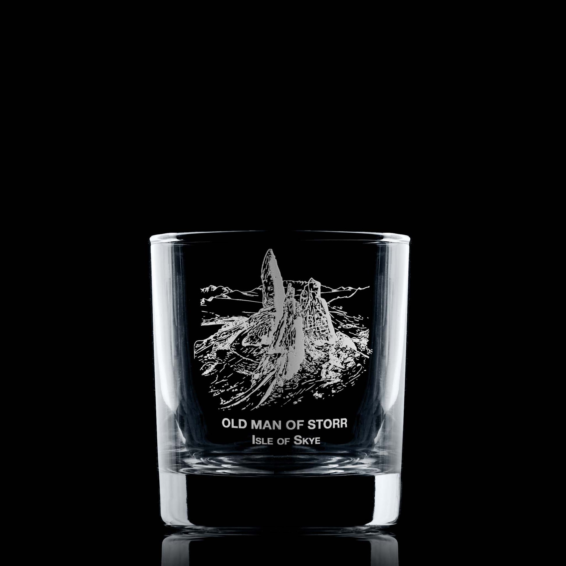 Engraved whisky glass featuring the Old Man of Storr and Isle of Skye text, shown on black background to highlight engraving detail