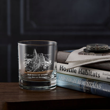 Isle of Skye whisky glass with engraved illustration of The Old Man of Storr next to a stack of mountain books