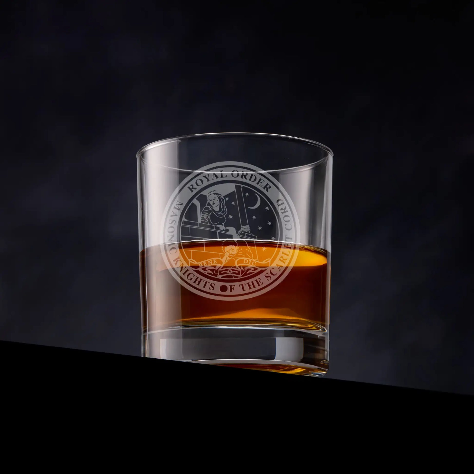 Masonic whisky glass featuring the Order of the Scarlet Cord emblem on a dark background