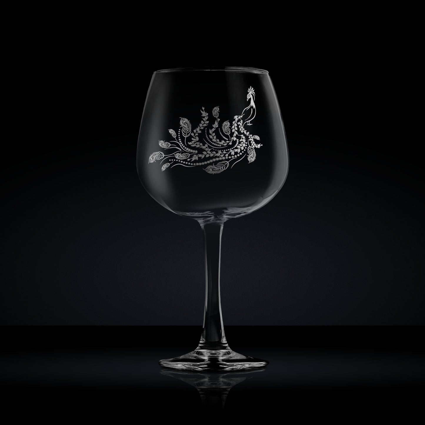 engraved balloon gin glass etched with a peacock 