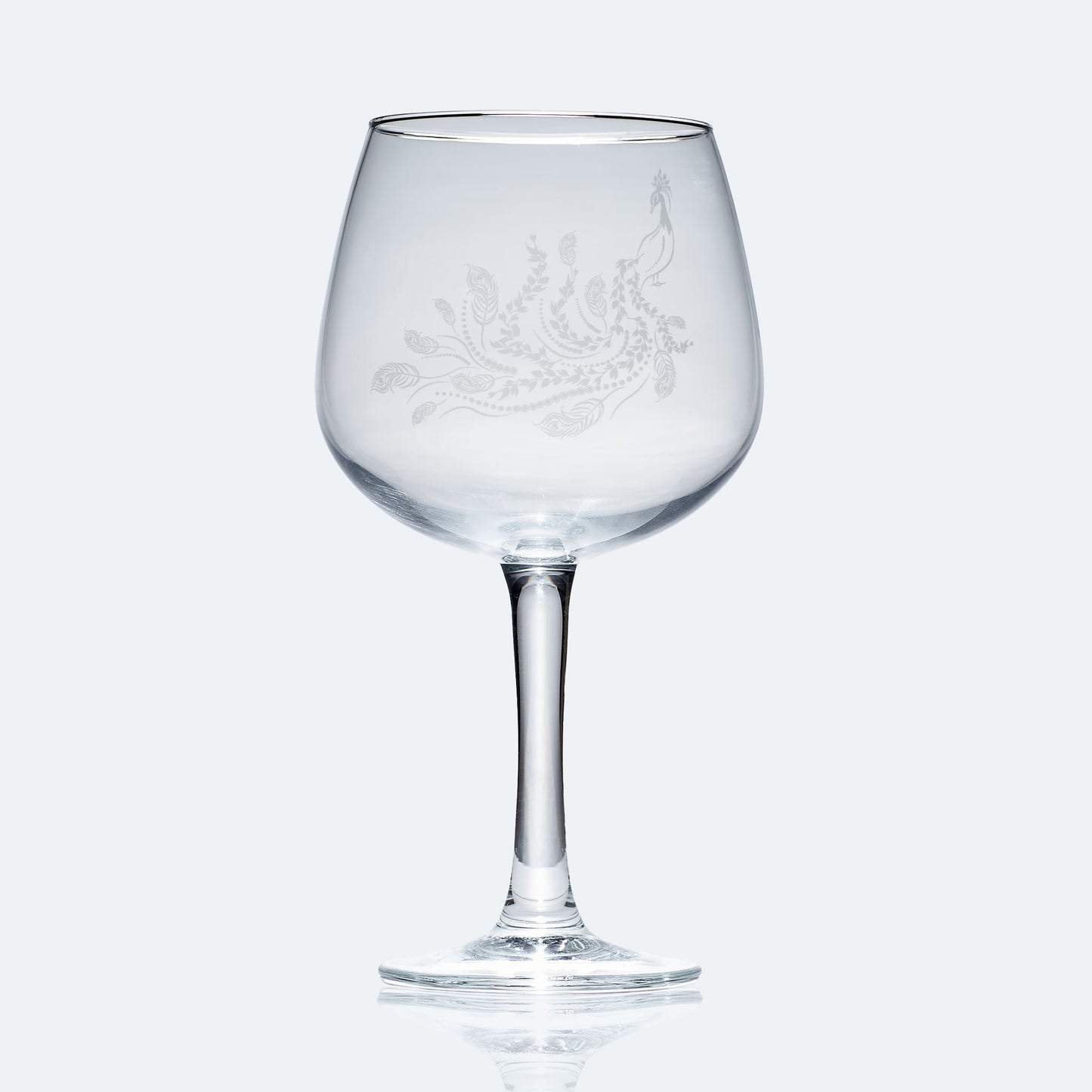 engraved balloon gin glass etched with a peacock 