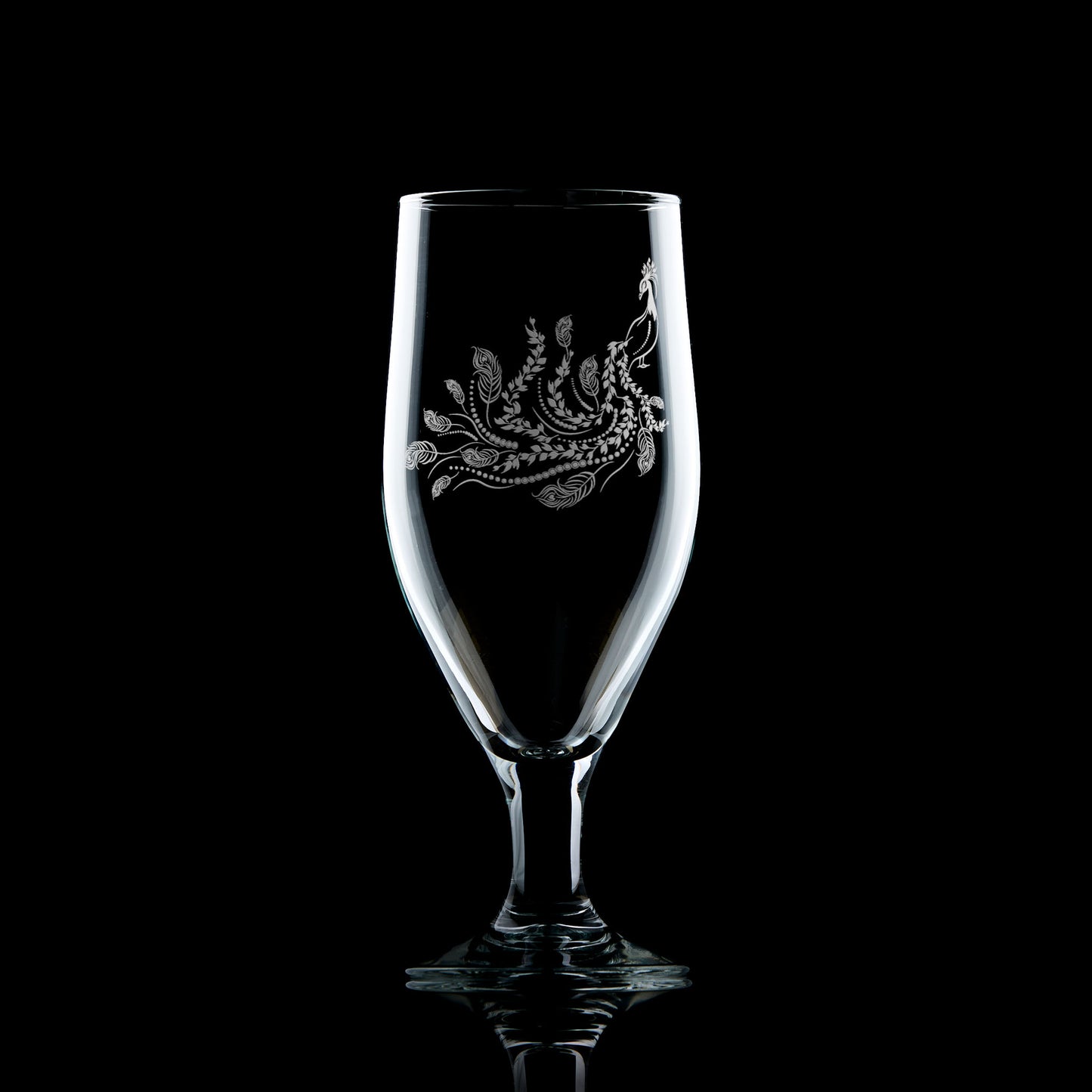 engraved stemmed beer glass etched with a peacock  and feathers