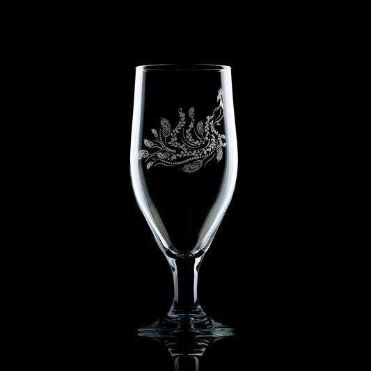 engraved stemmed beer glass etched with a peacock  and feathers