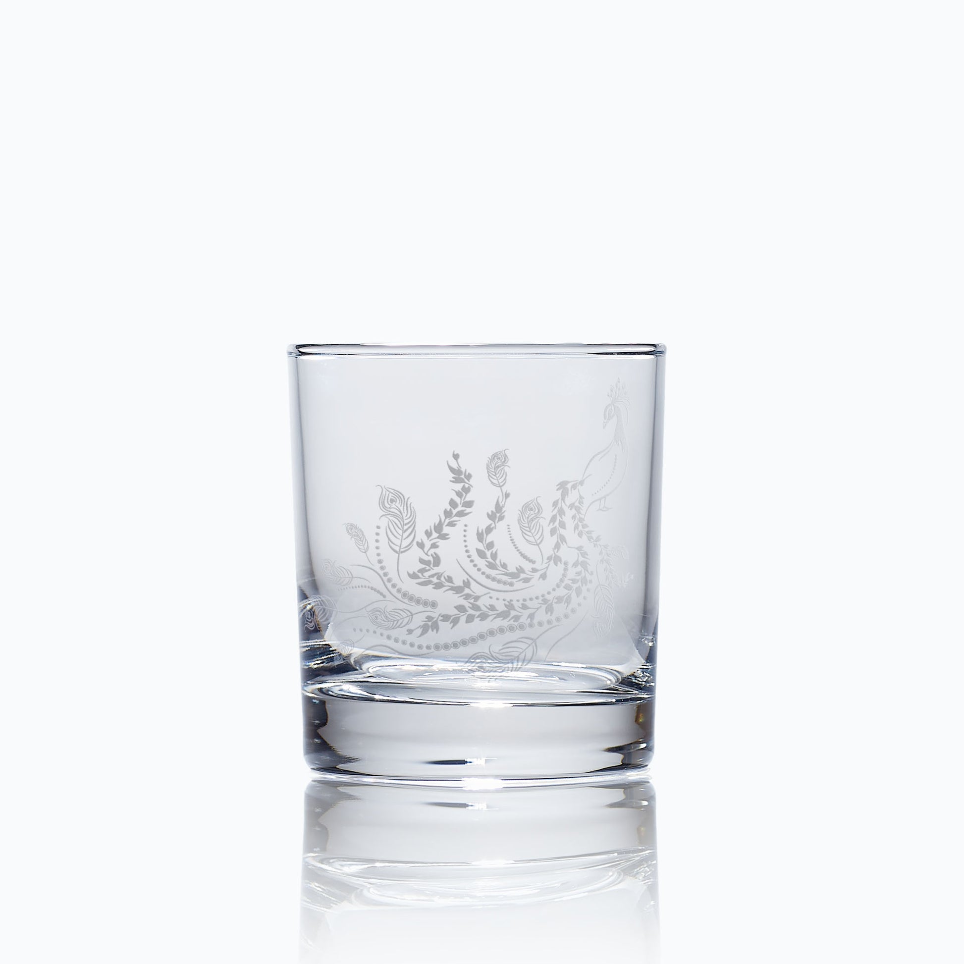 engraved whisky glass etched with a peacock 