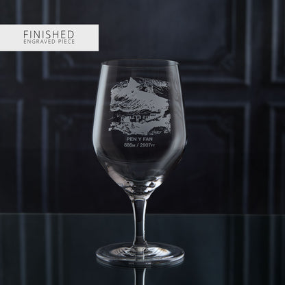 Stemmed water glass with engraved welsh mountain design on a dark background