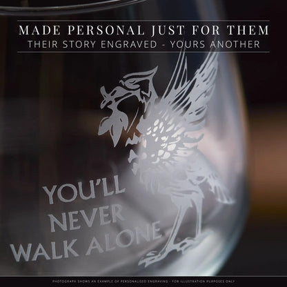 Personalised engraved glass with bird design and text on a dark background