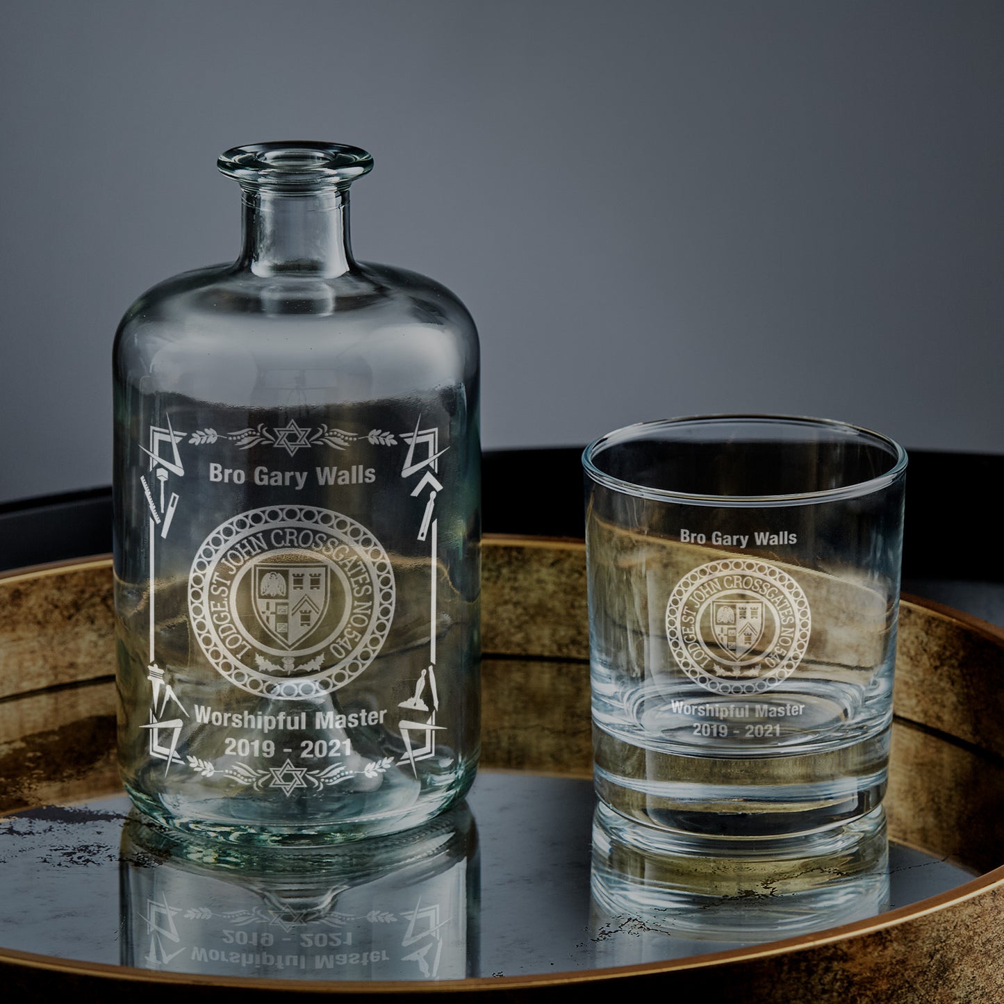 Apothecary bottle and whisky tumbler engraved with a personalised message and masonic lodge design