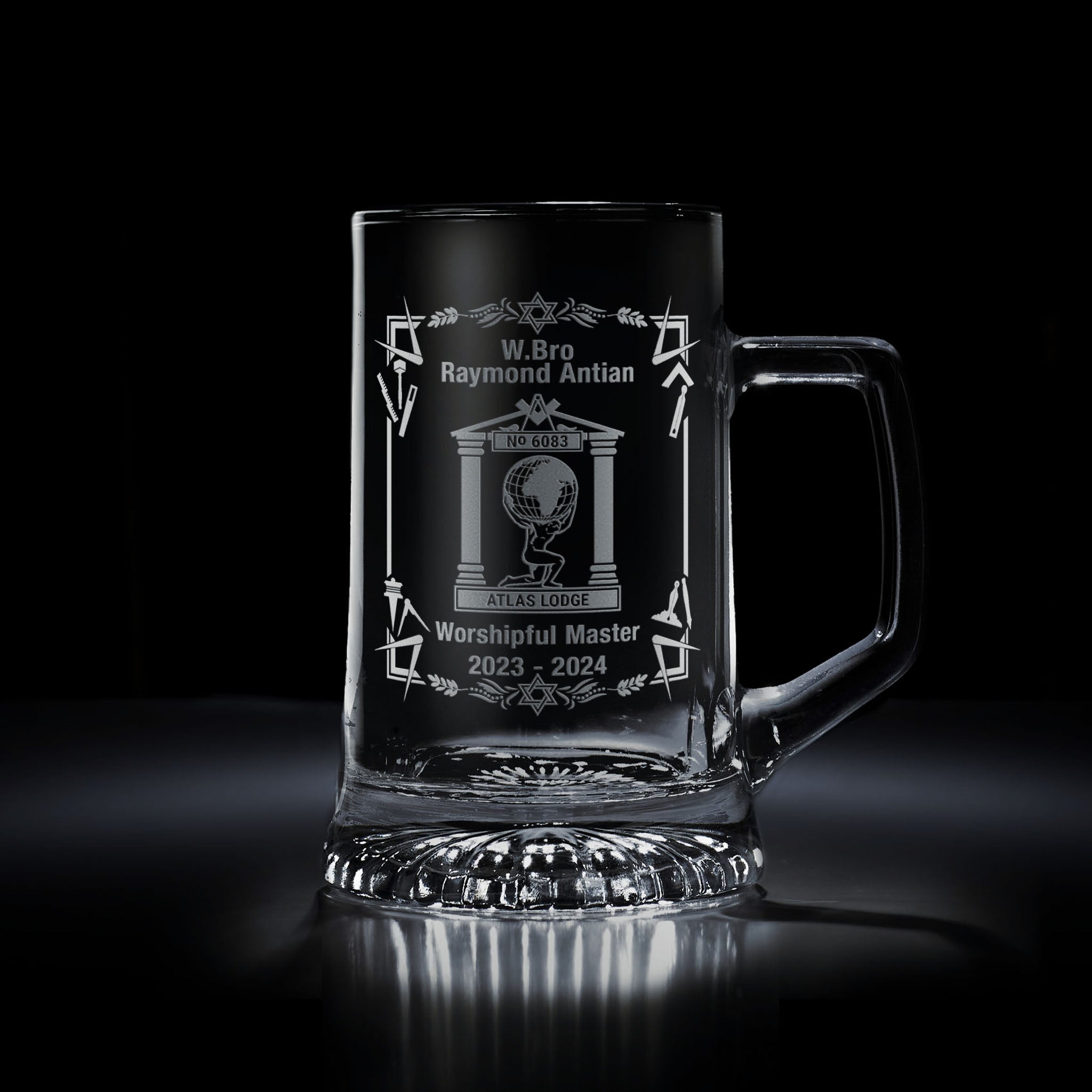 Masonic tankard with engraved lodge crest and symbolic rectangular frame, shown on black background