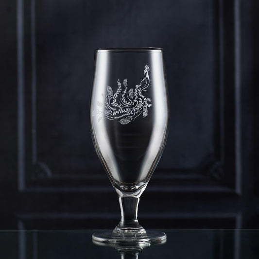Stemmed beer glass engraved with a peacock with feathers and trailing leaves, inspired by Pittencrieff Park’s flora