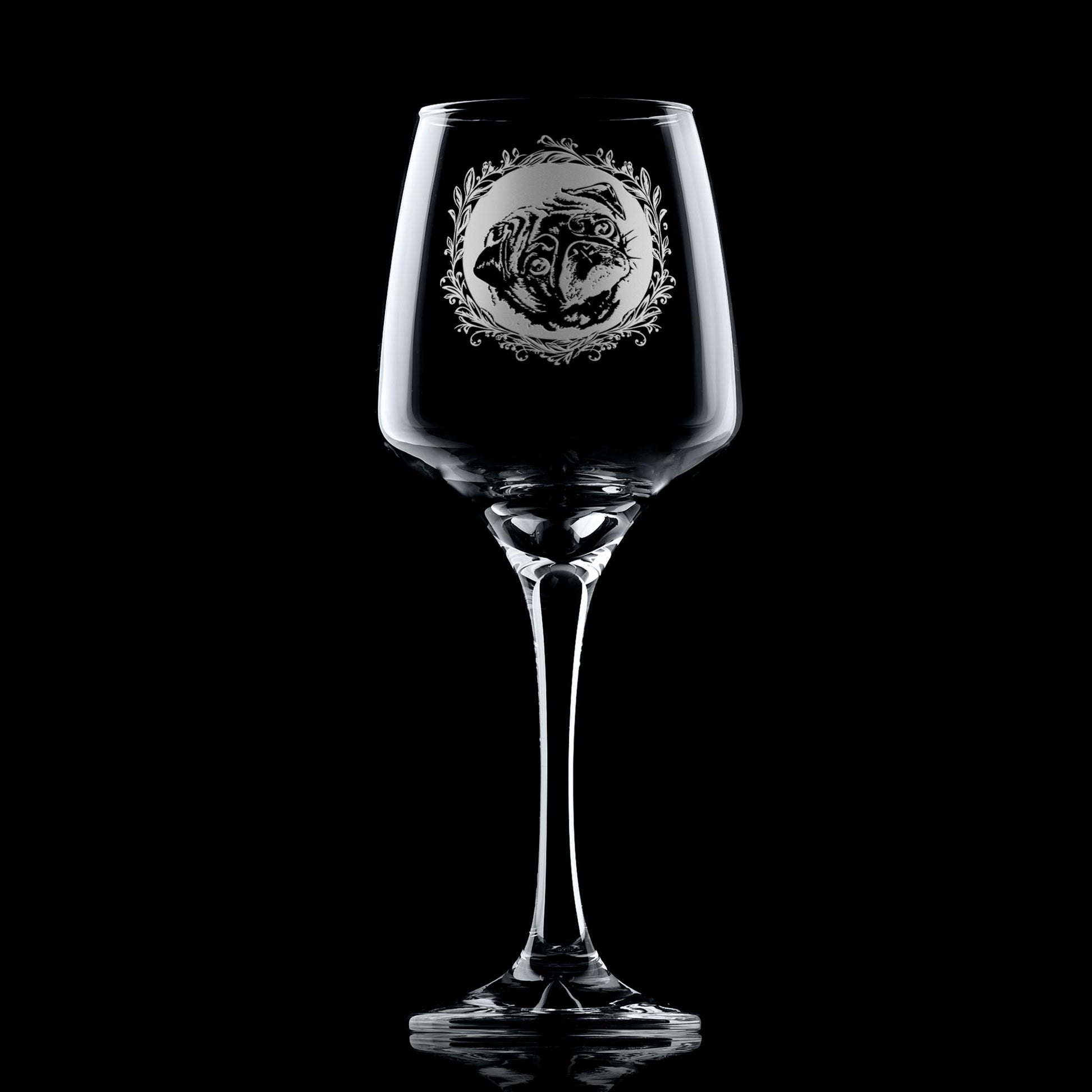 Wine glass with engraved pug dog portrait in circular frame with leafy garland
