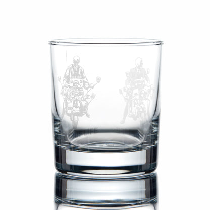 Clear glass whiskey tumbler with engraved scooter design on a white background