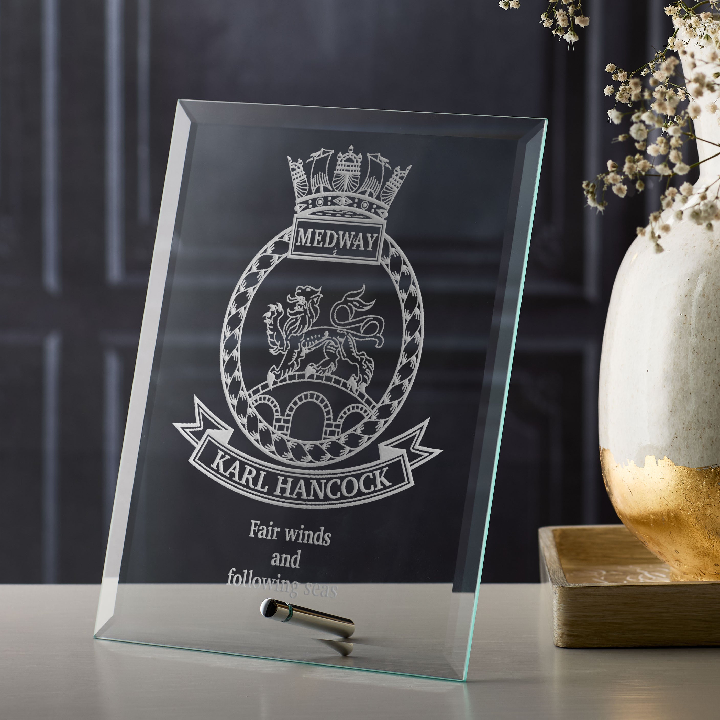 Retirement glass plaque with engraved crest design and personalised text on a dark background