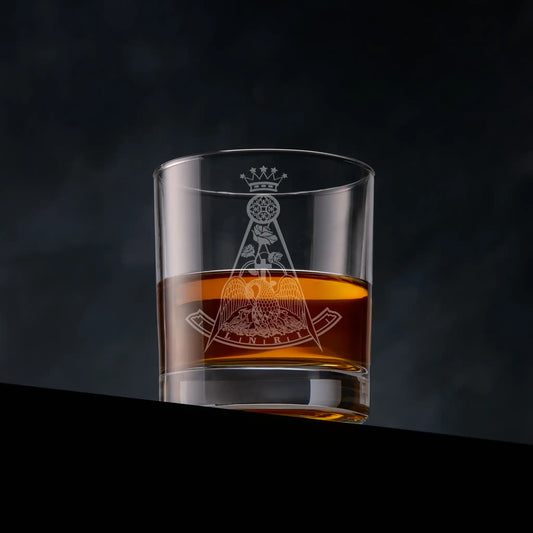 Masonic whisky glass engraved with a Rose Croix Collar Jewel, 18th degree and photographed on a dark background