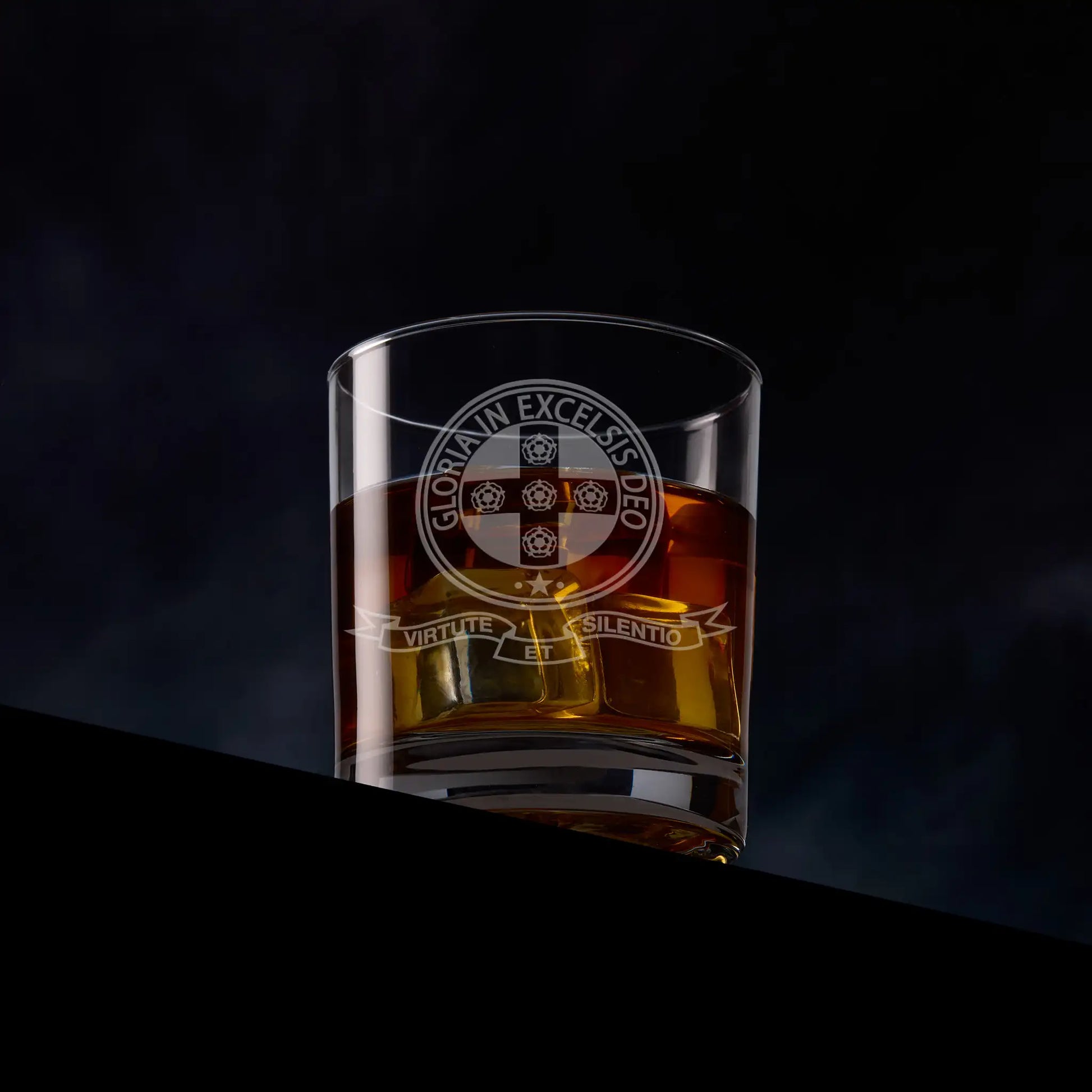 Engraved Royal Order of Scotland whisky glass with emblem, photographed on black background